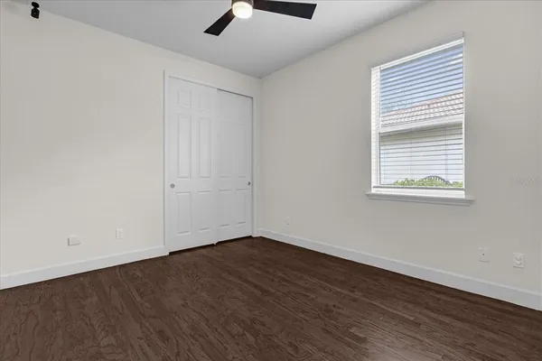 a view of an empty room with wooden floor