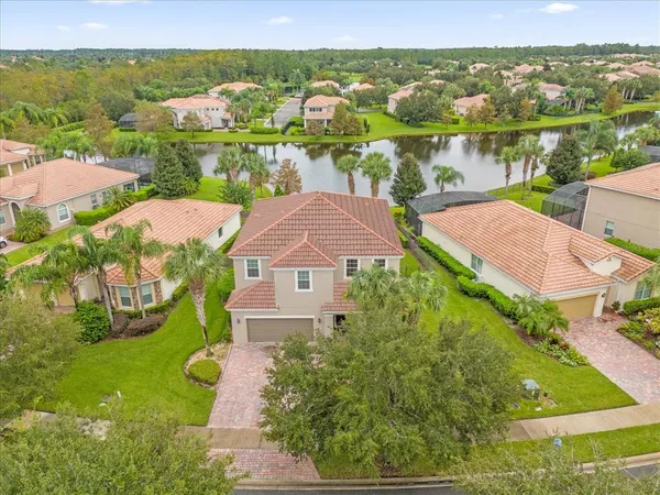 an aerial view of residential houses with outdoor space and river