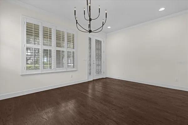 a view of wooden floor and a chandelier in a room