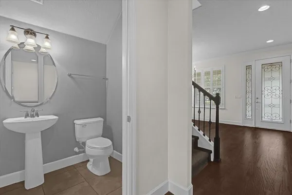 a bathroom with a toilet a sink and a mirror