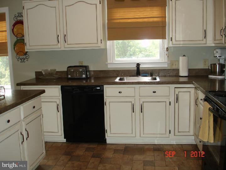 696 Guernsey Road South Landenberg, PA 19350 - Photo 12 of 25 a kitchen with white cabinets and sink