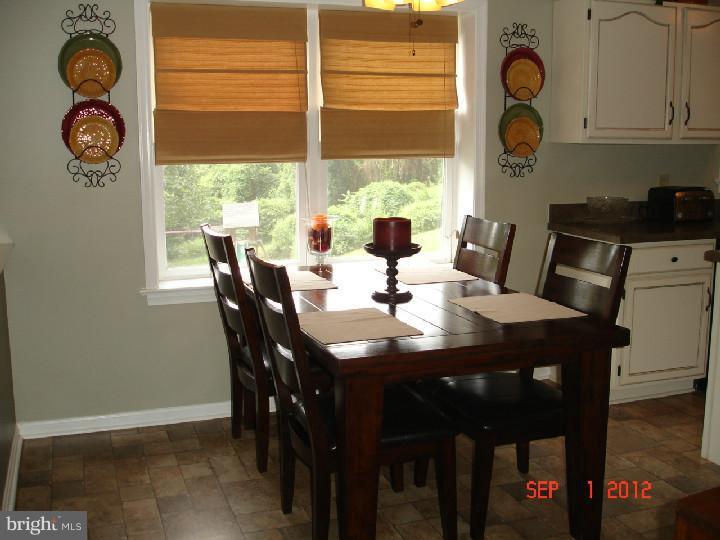696 Guernsey Road South Landenberg, PA 19350 - Photo 13 of 25 a view of a dining room with furniture and a window