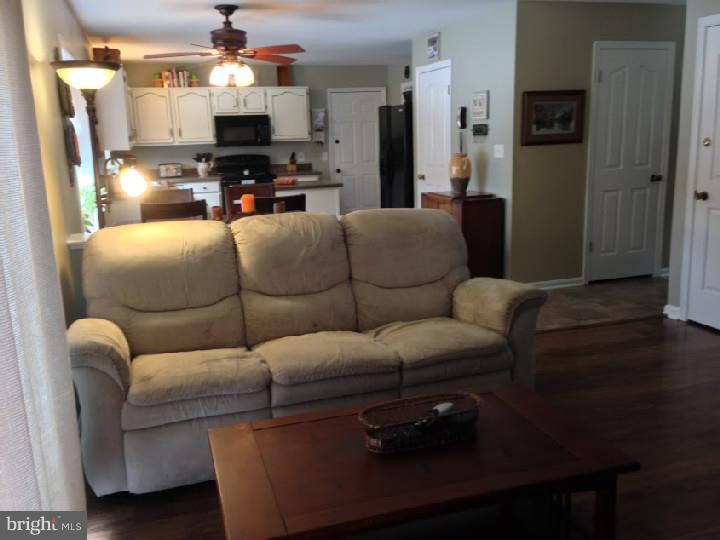 696 Guernsey Road South Landenberg, PA 19350 - Photo 14 of 25 a living room with furniture a flat screen tv and kitchen view