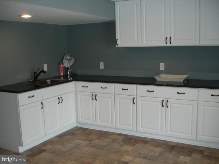 696 Guernsey Road South Landenberg, PA 19350 - Photo 25 of 25 a kitchen with granite countertop white cabinets and sink