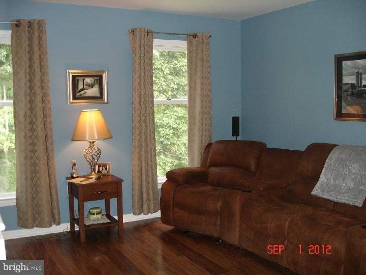 696 Guernsey Road South Landenberg, PA 19350 - Photo 8 of 25 a living room with furniture and a lamp
