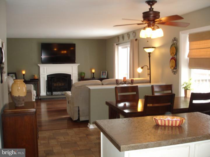 696 Guernsey Road South Landenberg, PA 19350 - Photo 10 of 25 a living room with furniture a fireplace and a flat screen tv