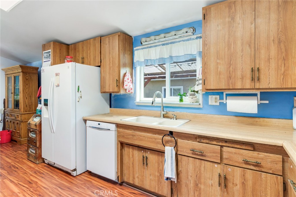 9579 Hampshire Street Rancho Cucamonga, CA 91730 - Photo 12 of 25 a kitchen with a refrigerator a sink and a stove