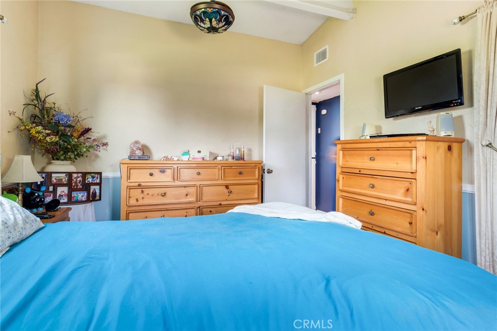 9579 Hampshire Street Rancho Cucamonga, CA 91730 - Photo 14 of 25 a bedroom with a bed and flat screen tv