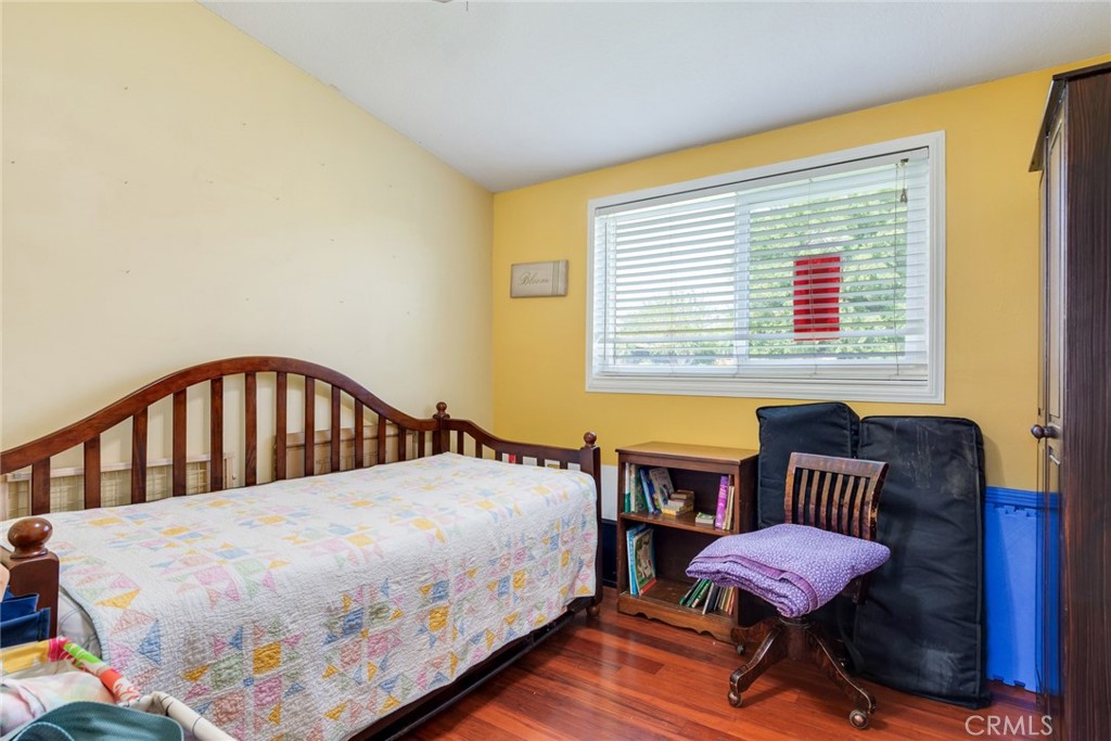 9579 Hampshire Street Rancho Cucamonga, CA 91730 - Photo 16 of 25 a bedroom with a bed and wooden floor