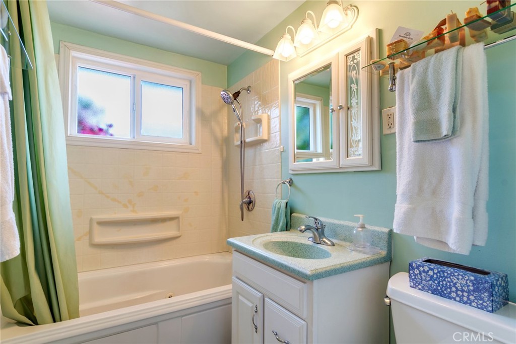 9579 Hampshire Street Rancho Cucamonga, CA 91730 - Photo 18 of 25 a bathroom with a granite countertop sink and a mirror