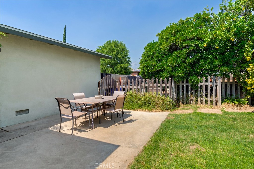 9579 Hampshire Street Rancho Cucamonga, CA 91730 - Photo 23 of 25 a view of a backyard with table and chairs and wooden fence