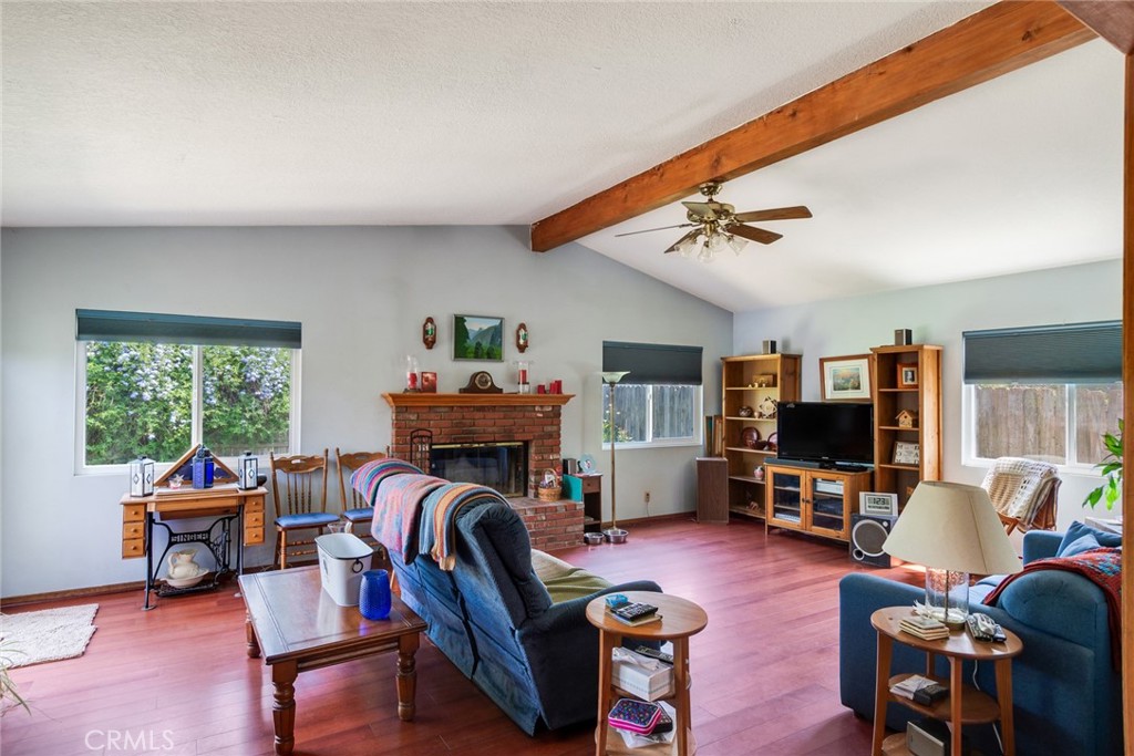 9579 Hampshire Street Rancho Cucamonga, CA 91730 - Photo 9 of 25 a living room with furniture a fireplace and a flat screen tv