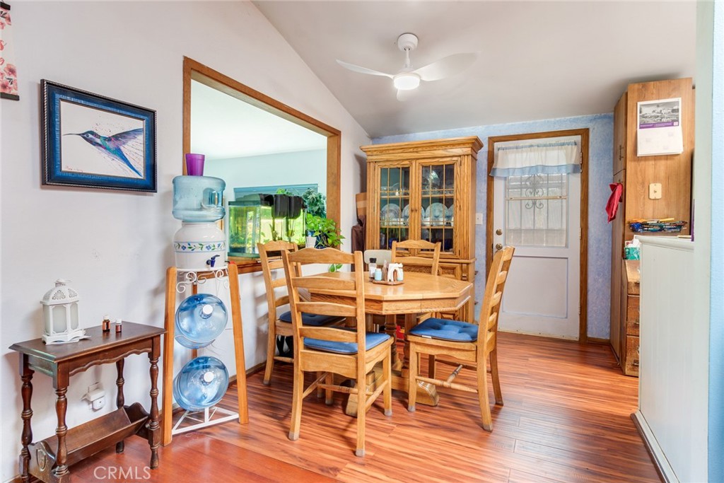 9579 Hampshire Street Rancho Cucamonga, CA 91730 - Photo 10 of 25 a dining room with furniture a floor to ceiling window and wooden floor