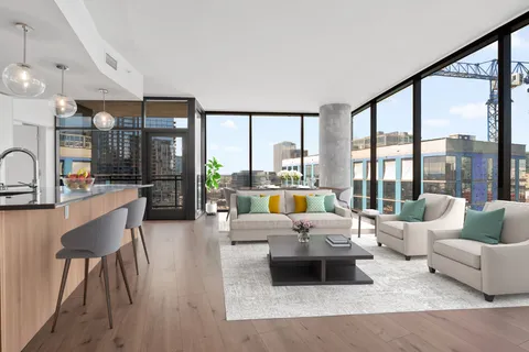 a living room with furniture and large windows