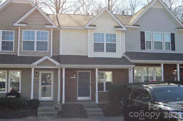 a front view of a house with parking space