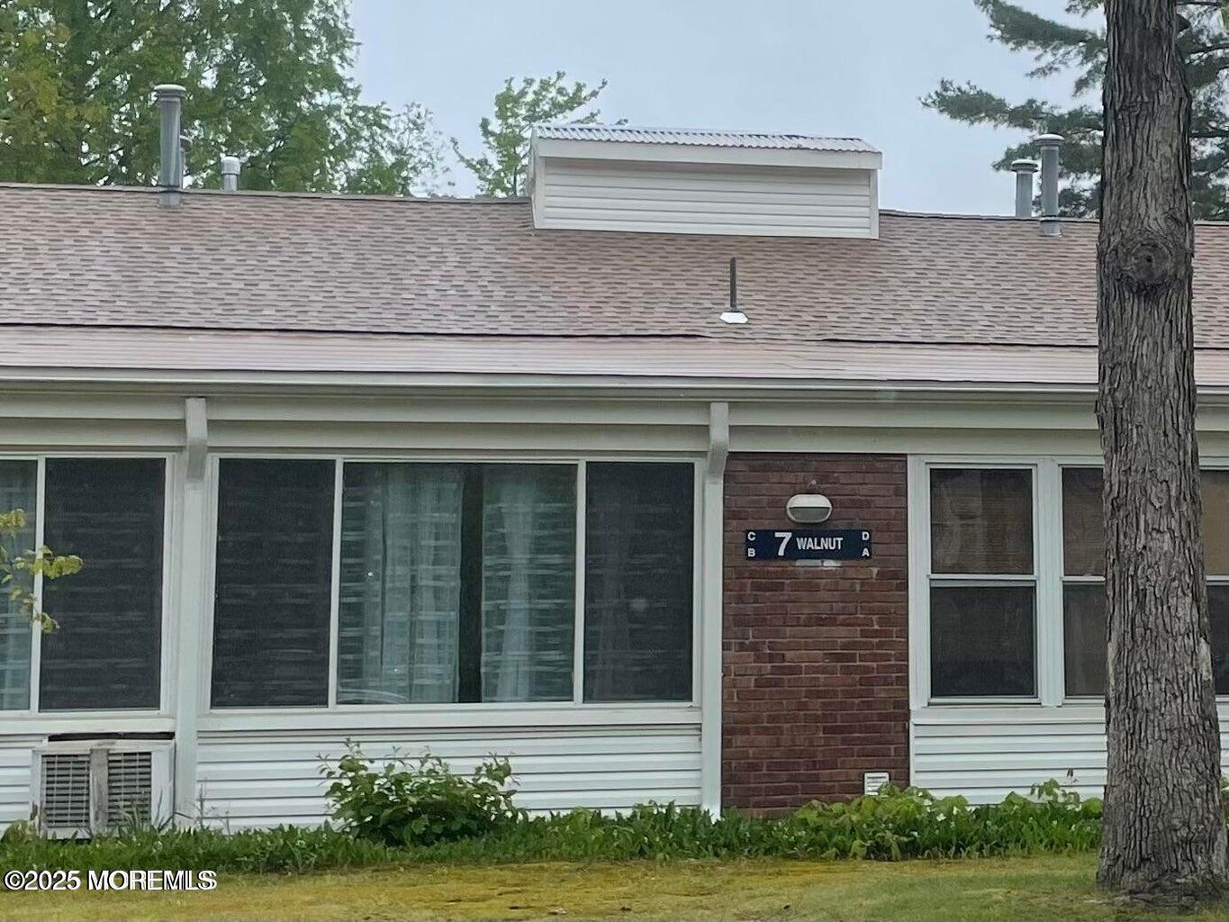 a front view of a house with garage and plants