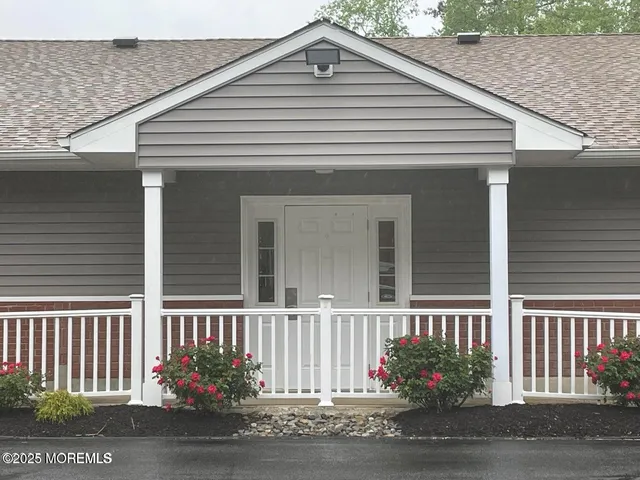 a front view of a house with a garden
