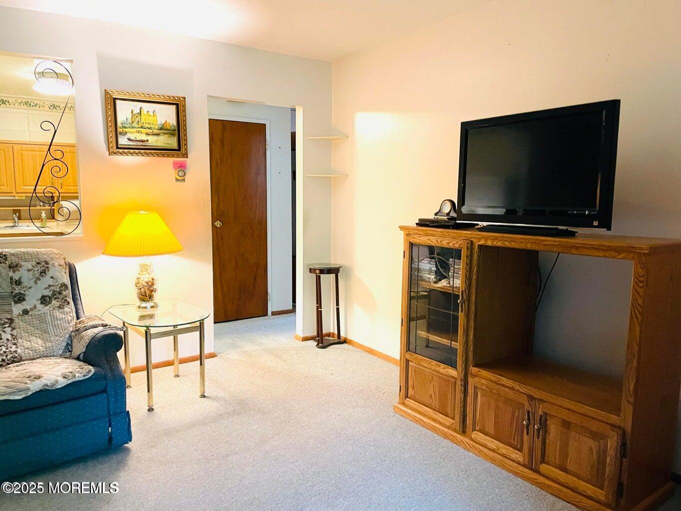 7 Walnut Street, Unit C Toms River, NJ 08757 - Photo 4 of 28 a living room with furniture and a flat screen tv