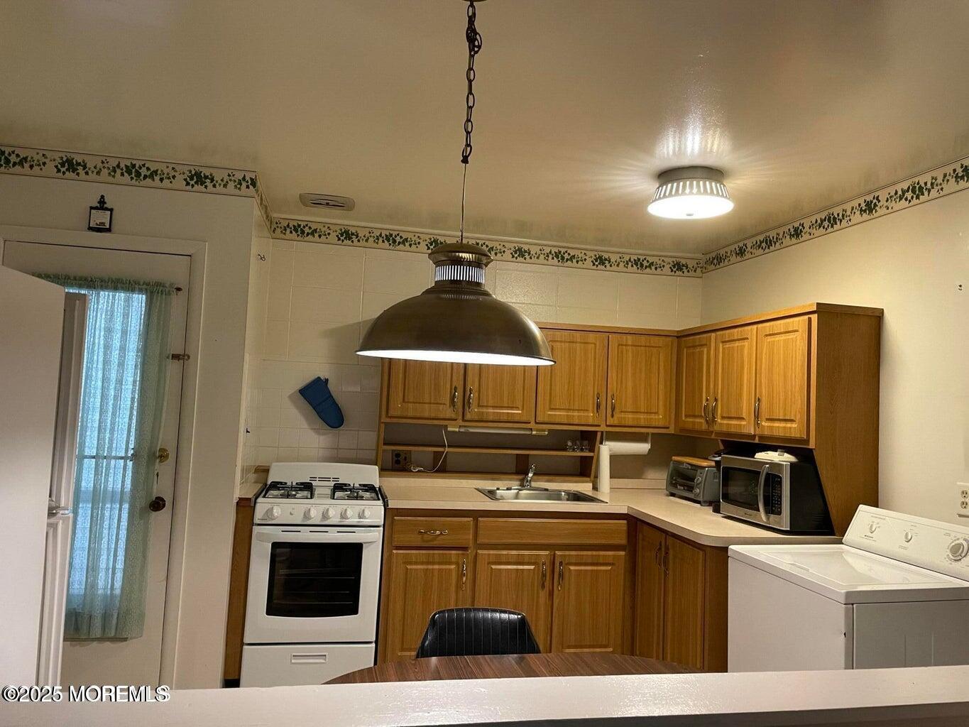 7 Walnut Street, Unit C Toms River, NJ 08757 - Photo 9 of 28 a kitchen with a stove and a refrigerator