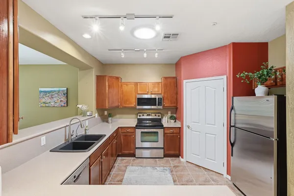 a kitchen with a refrigerator and sink