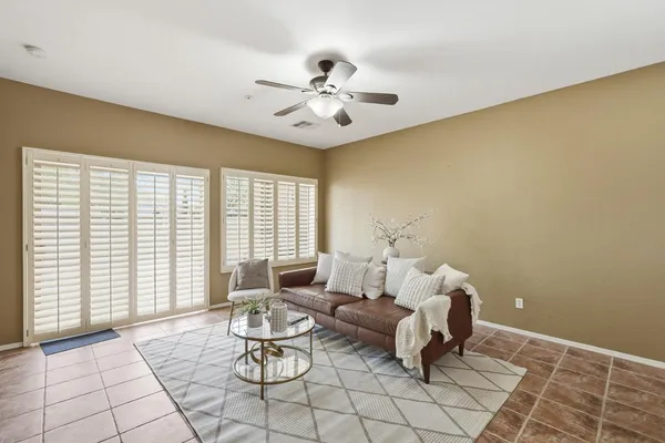 a living room with furniture and a chandelier