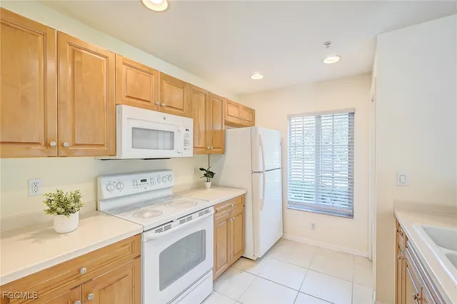 a utility room with cabinets washer and dryer