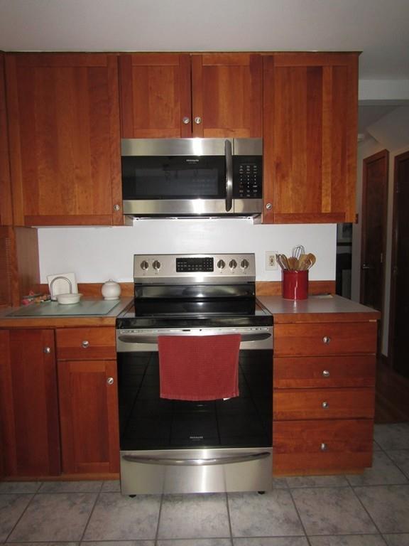 1300 Burts Pit Road Northampton, MA 01062 - Photo 8 of 39 a kitchen with stainless steel appliances granite countertop a stove a microwave and a refrigerator