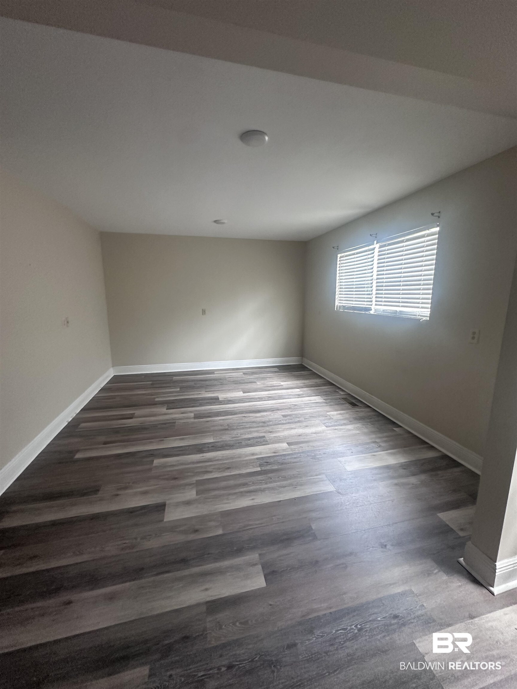 2785 Sowell Road Brewton, AL 36426 - Photo 10 of 24 Unfurnished room with dark wood-style flooring and baseboards