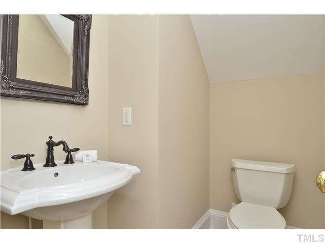 8311 Cazavini Court Raleigh, NC 27613 - Photo 11 of 22 a bathroom with a toilet sink and mirror