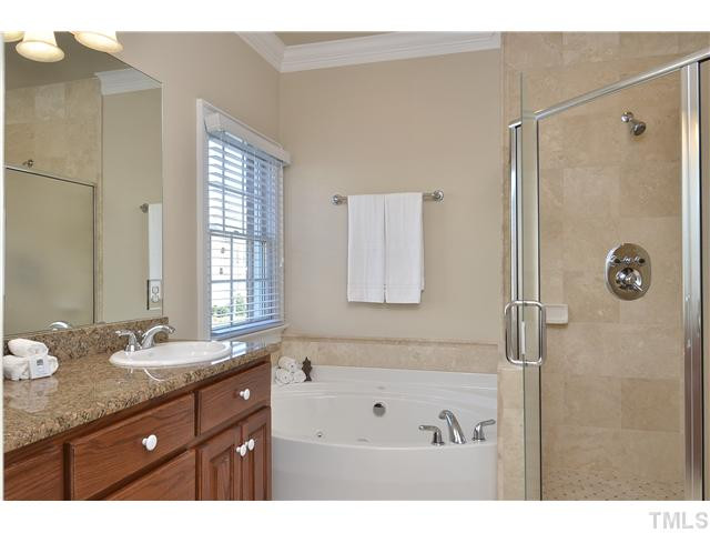 8311 Cazavini Court Raleigh, NC 27613 - Photo 15 of 22 a bathroom with a granite countertop sink mirror and a bathtub