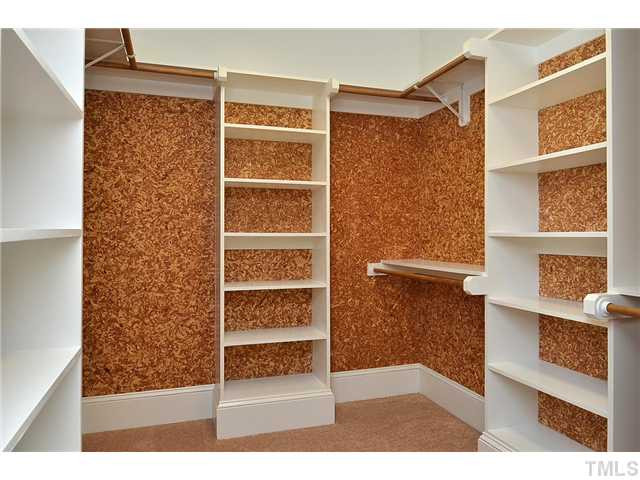 8311 Cazavini Court Raleigh, NC 27613 - Photo 16 of 22 a view of walk in closet with clothes and shoes