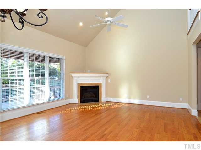 8311 Cazavini Court Raleigh, NC 27613 - Photo 9 of 22 a view of an empty room with a window and wooden floor