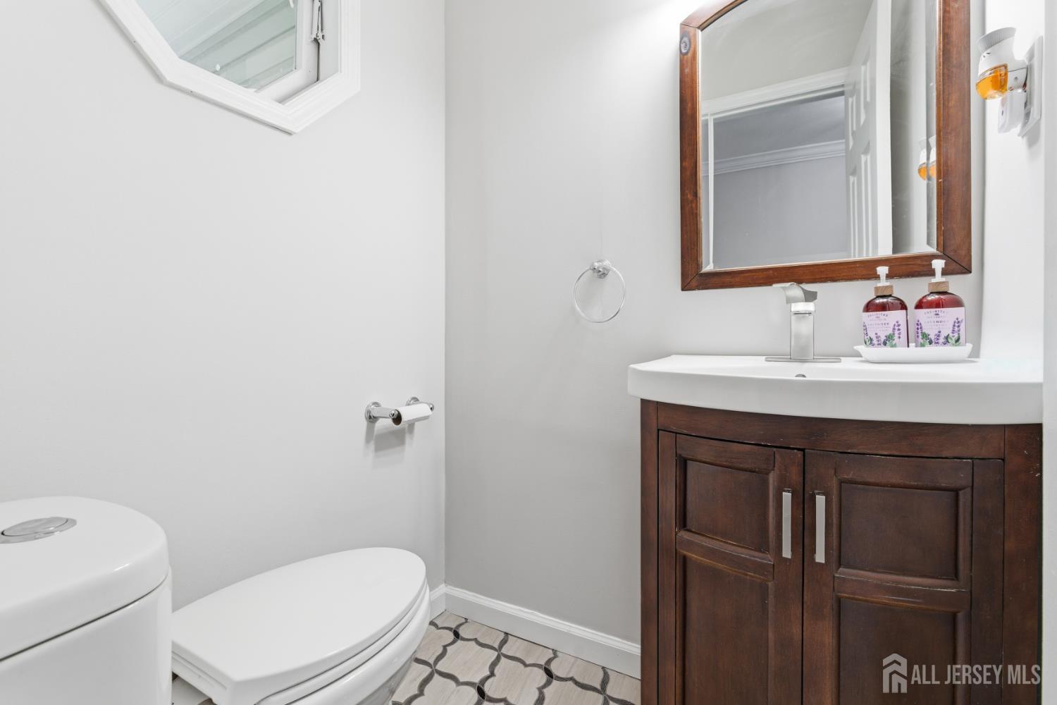 5 McKinley Street Edison, NJ 08820 - Photo 17 of 38 a bathroom with a sink vanity mirror and toilet