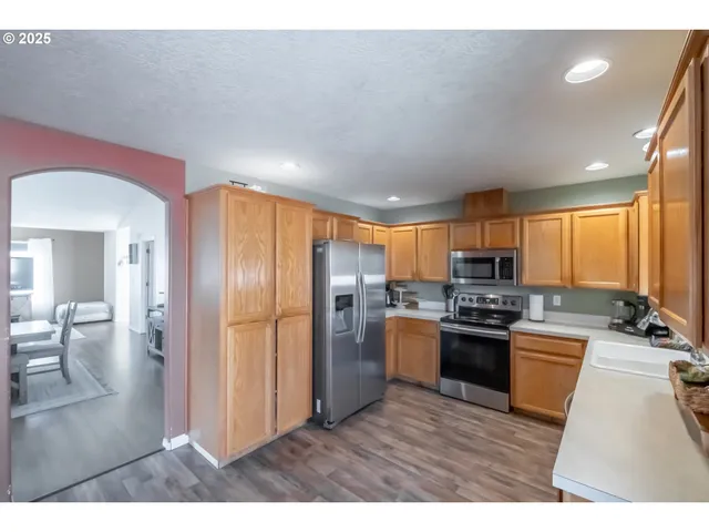 a view of a dining room with furniture and a chandelier