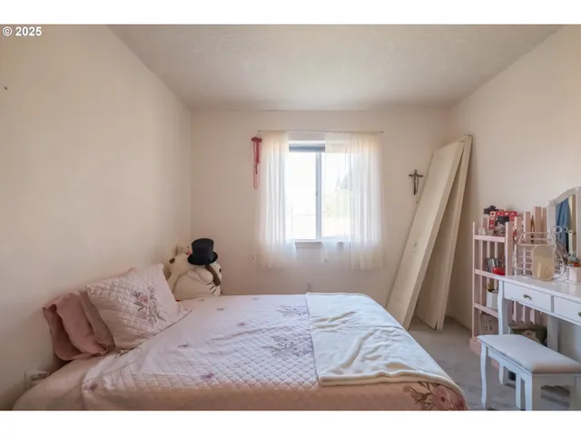 a bedroom with a bed and a large mirror