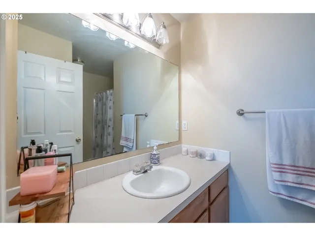a bathroom with a shower curtain and a sink