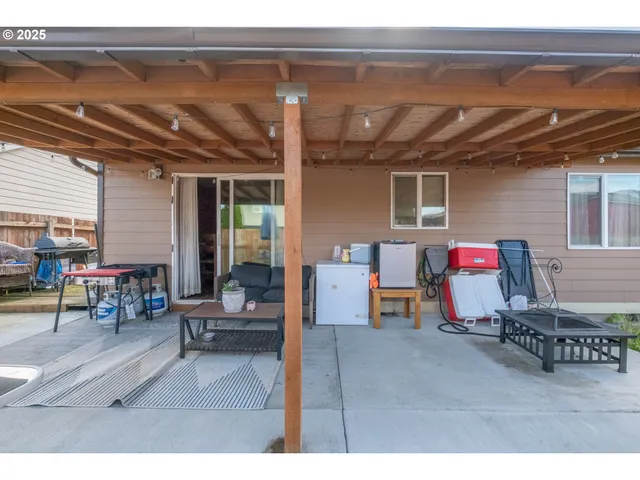 a building outdoor space with patio furniture and potted plants
