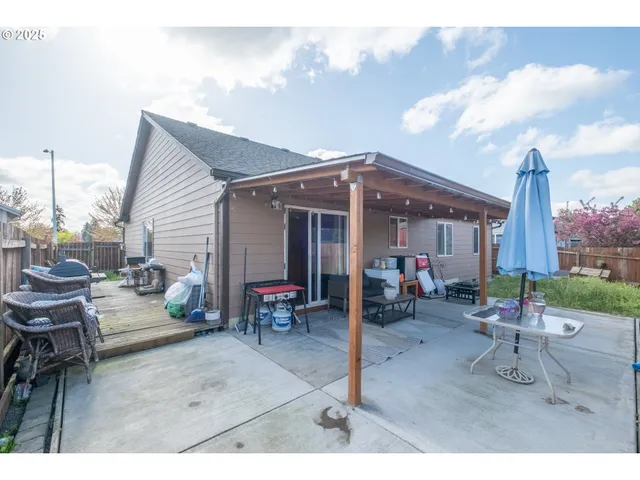 a view of a patio with table and chairs potted plants with wooden fence