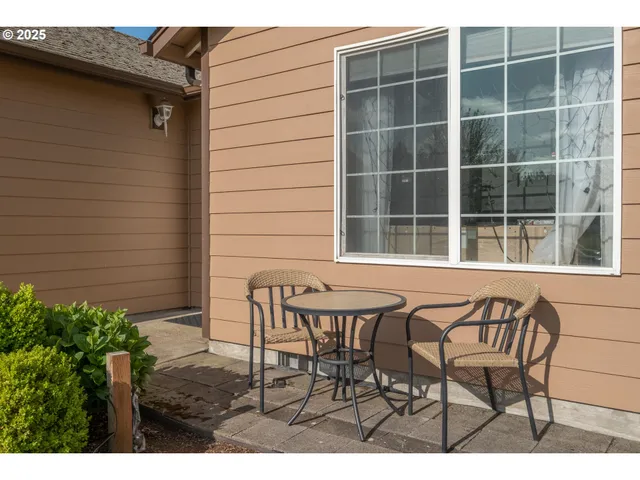 a view of a house with backyard and sitting area
