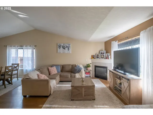 a view of a dining room with furniture and chandelier
