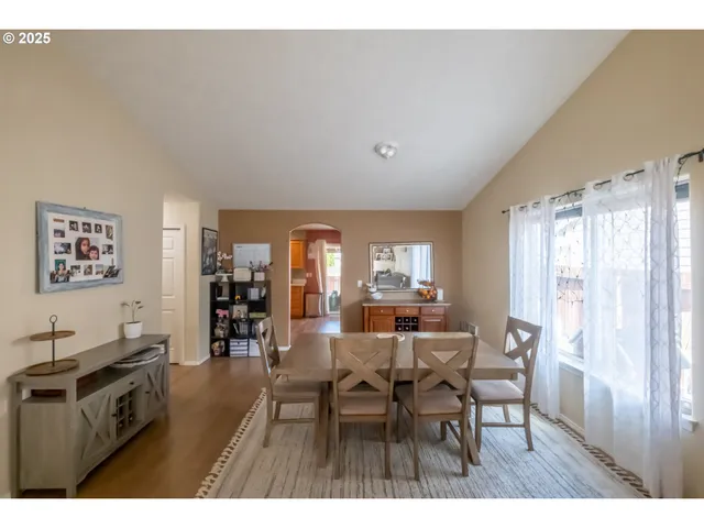 a kitchen with stainless steel appliances granite countertop a refrigerator a sink and a stove