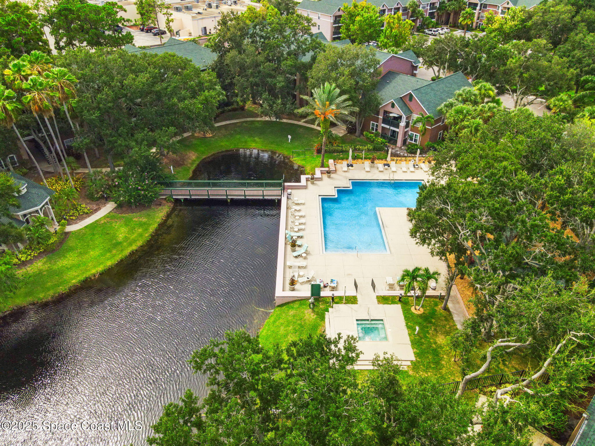 a aerial view of a house with a yard and lake view