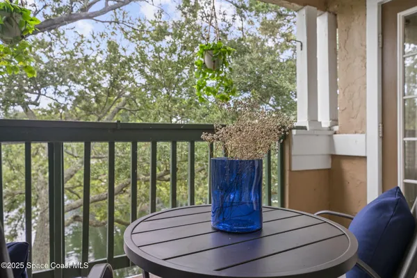 a view of a lake with a bench and trees
