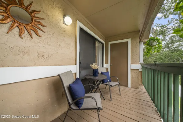 a view of a lake with a bench and trees around