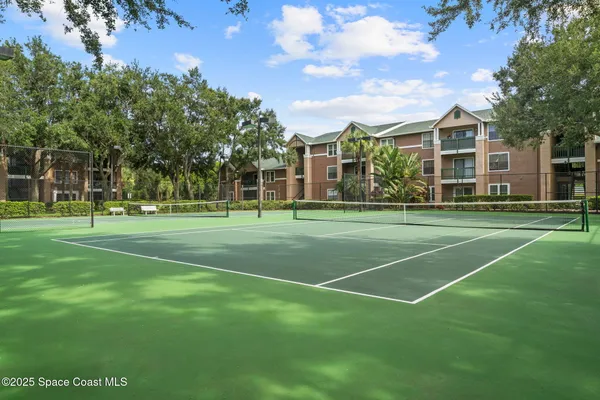 a aerial view of a house with a yard and lake view