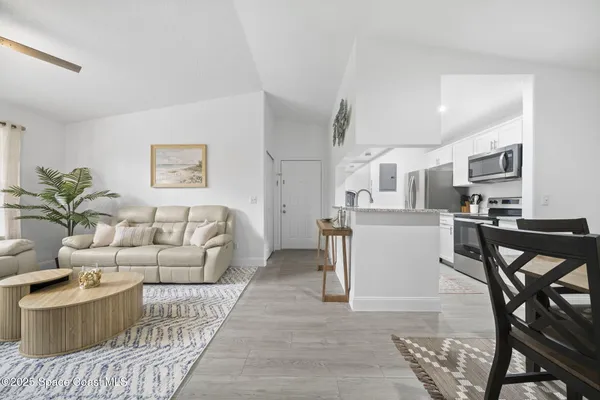 a view of a dining room with furniture and wooden floor