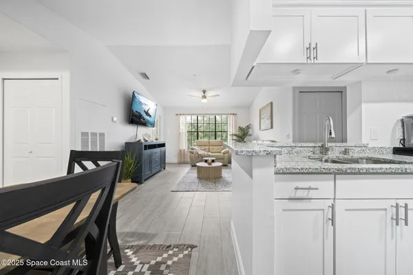 a kitchen with granite countertop a stove top oven microwave and cabinets