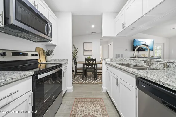 a large bathroom with a granite countertop sink