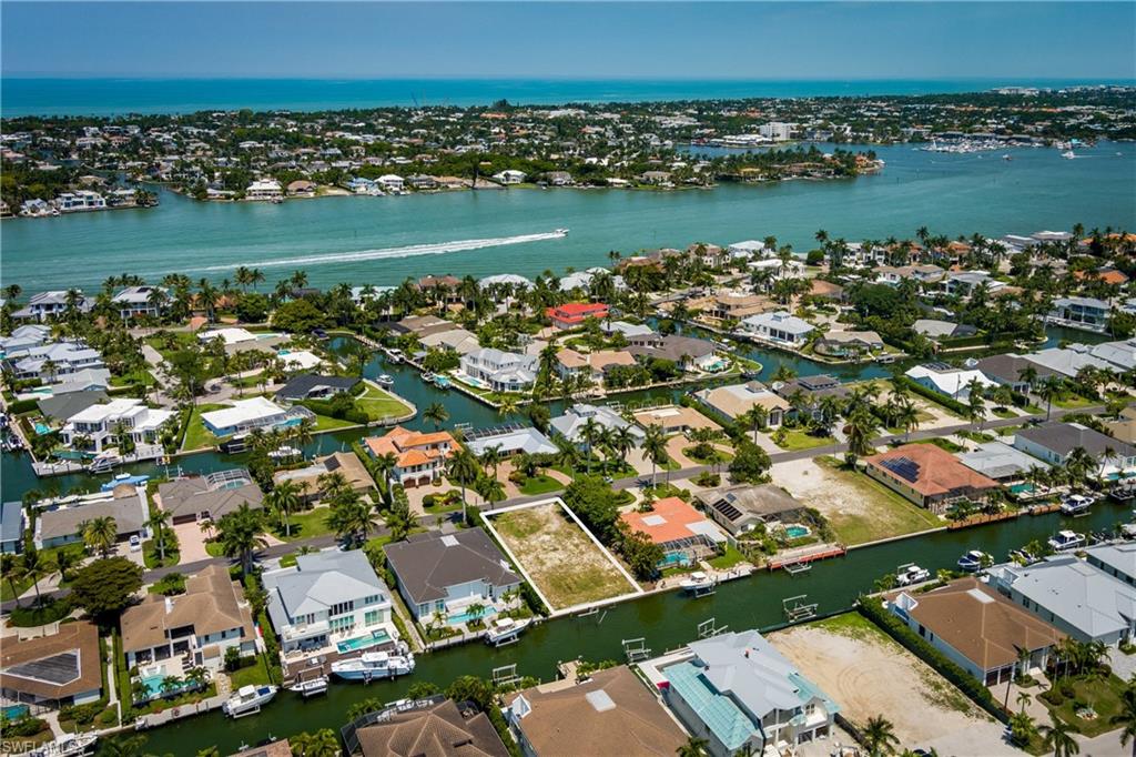 2165 Tarpon Road Naples, FL 34102 - Photo 21 of 24 an aerial view of a city with lots of residential buildings ocean and mountain view in back