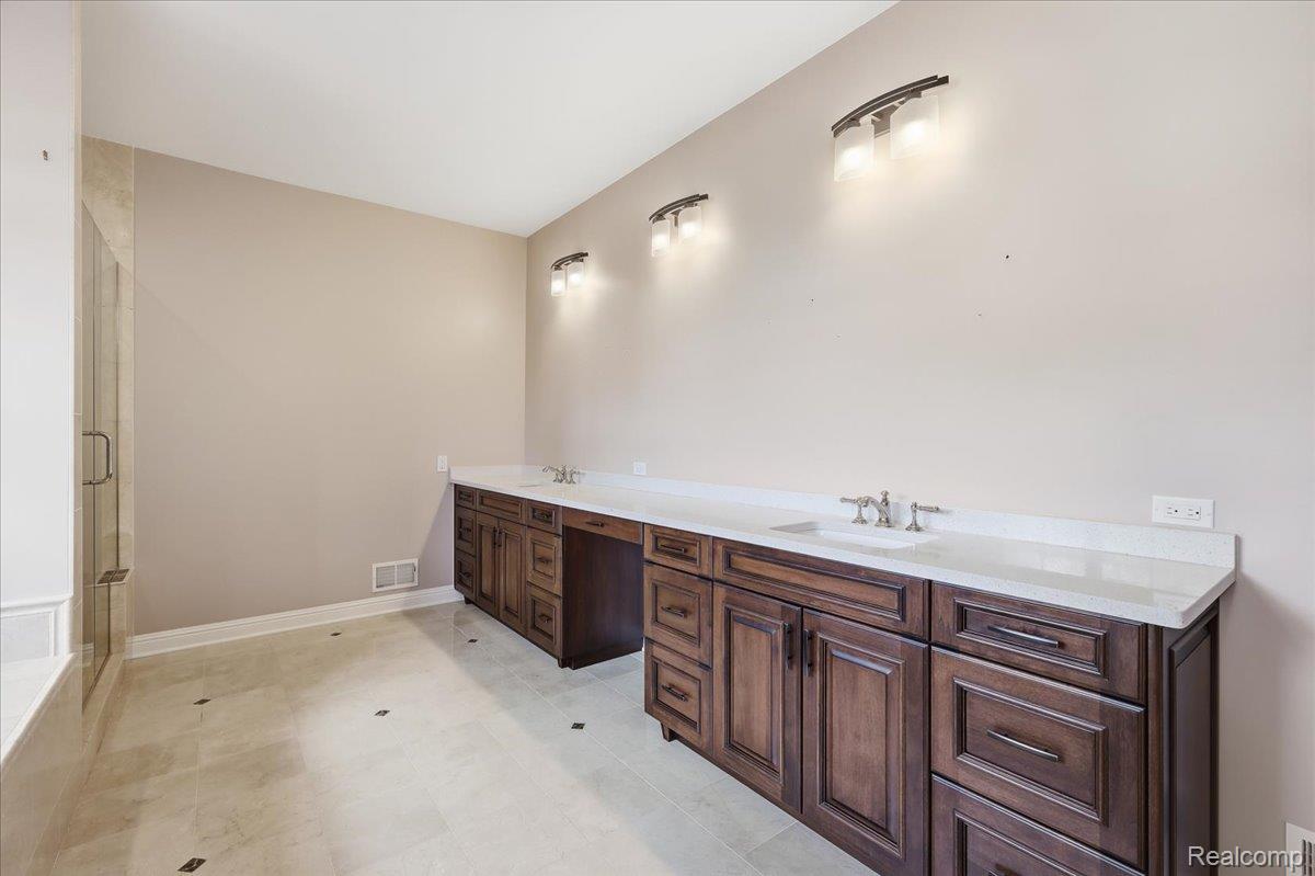 35339 West 13 Mile Road Farmington, MI 48331 - Photo 28 of 72 Primary bathroom featuring double vanity and a shower stall